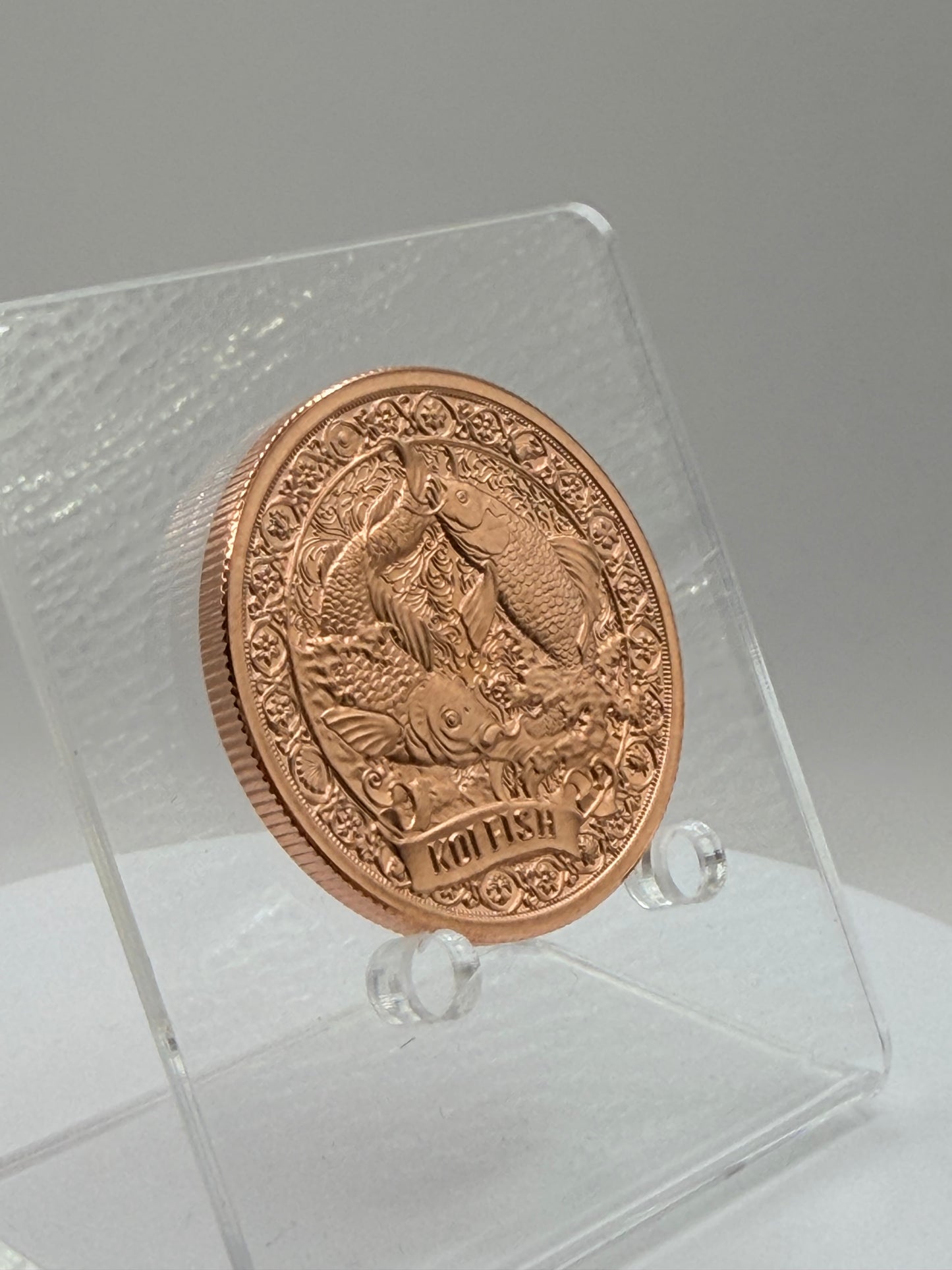copper bullion round featuring symbolic koi fish artwork