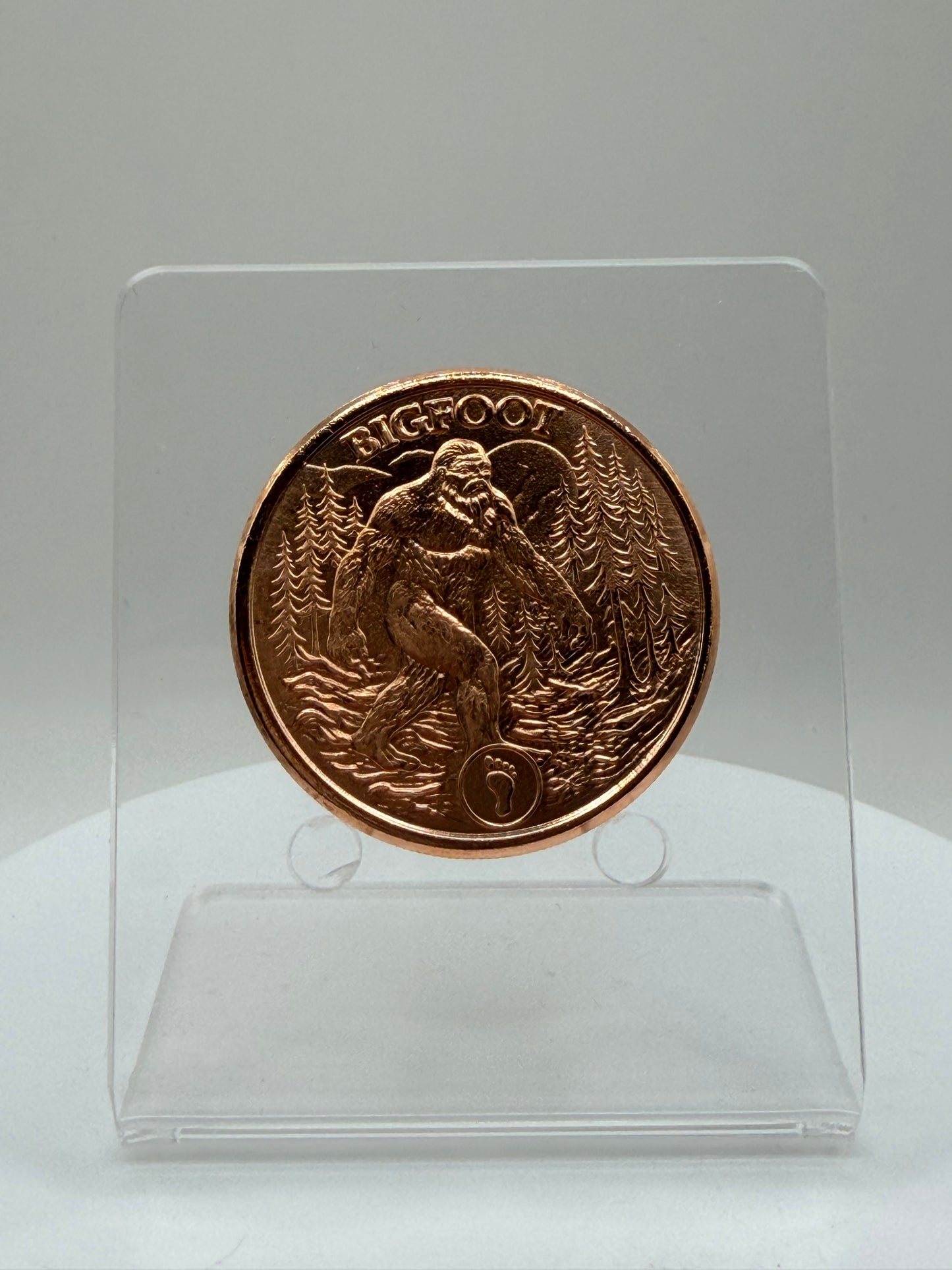sasquatch copper collectible coin featuring woodland mountain design