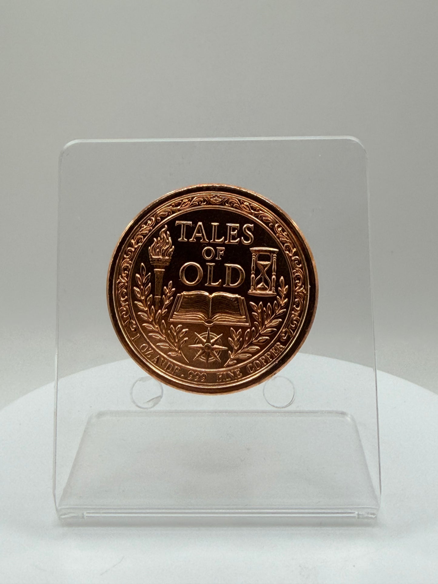 copper coin reverse featuring book torch compass and hourglass