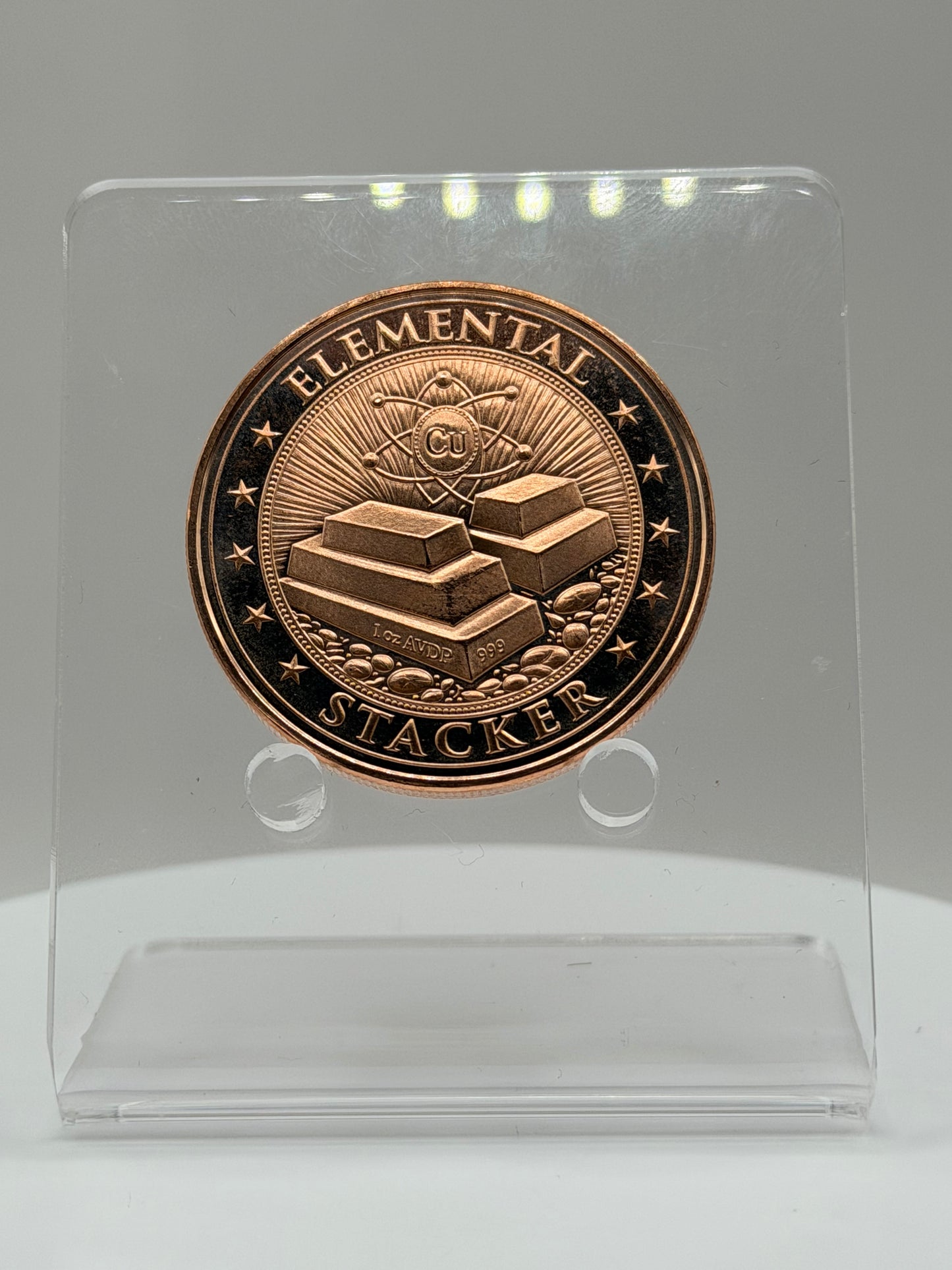 close-up detail of highdesertmint elemental stacker 1 oz .999 fine copper round showing engraved copper bars and atomic symbol